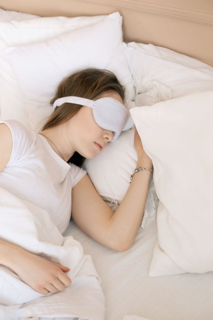 Young woman sleeping in bed to maintain her best mental health